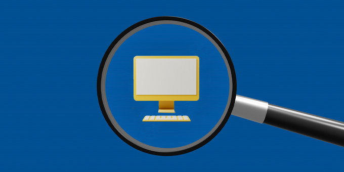 Magnifying glass looking at a computer screen